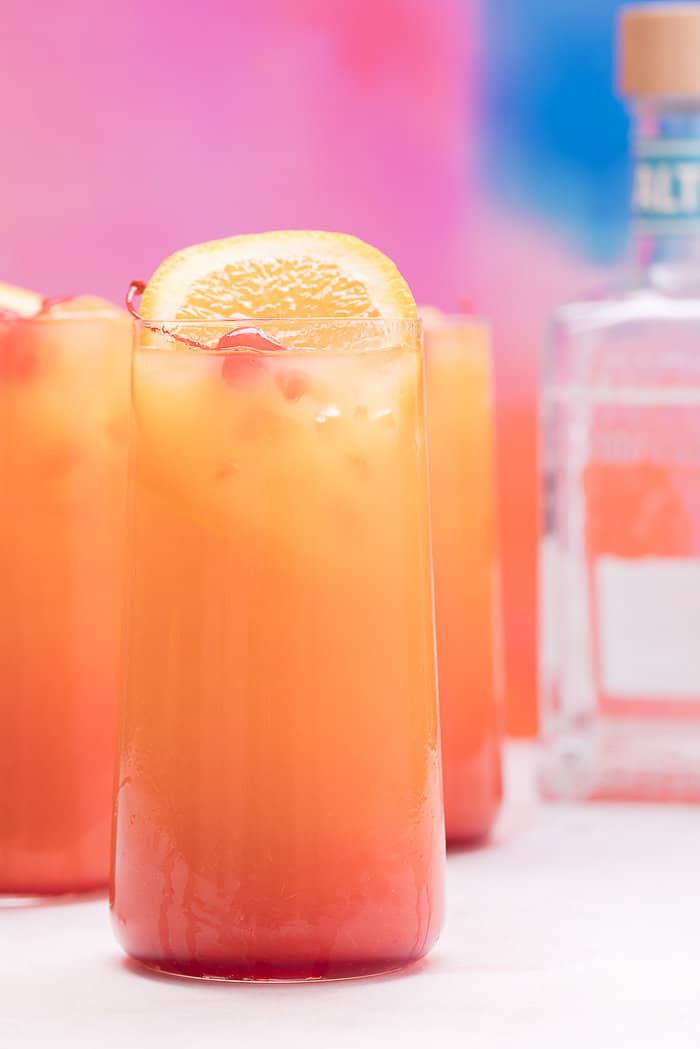 Three tall glasses of tequila sunrise.